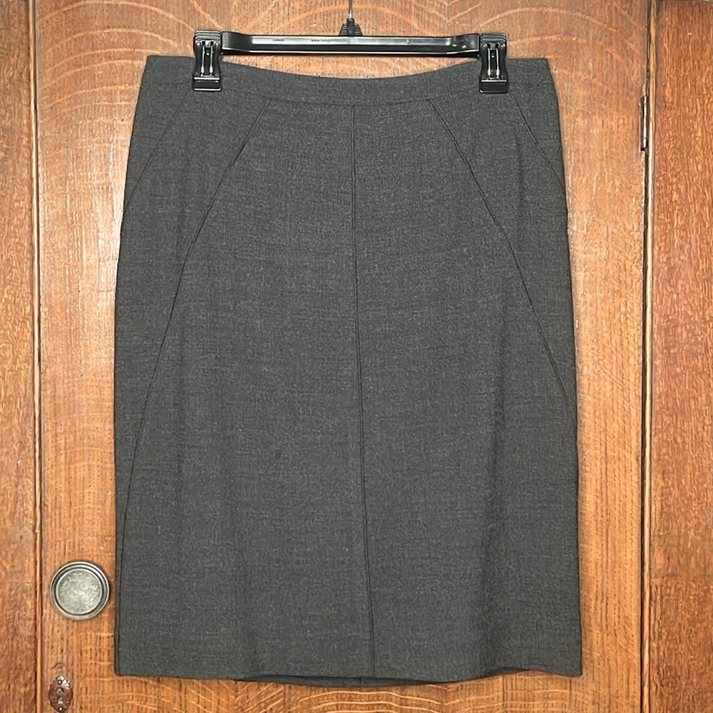 Short charcoal gray paneled skirt.